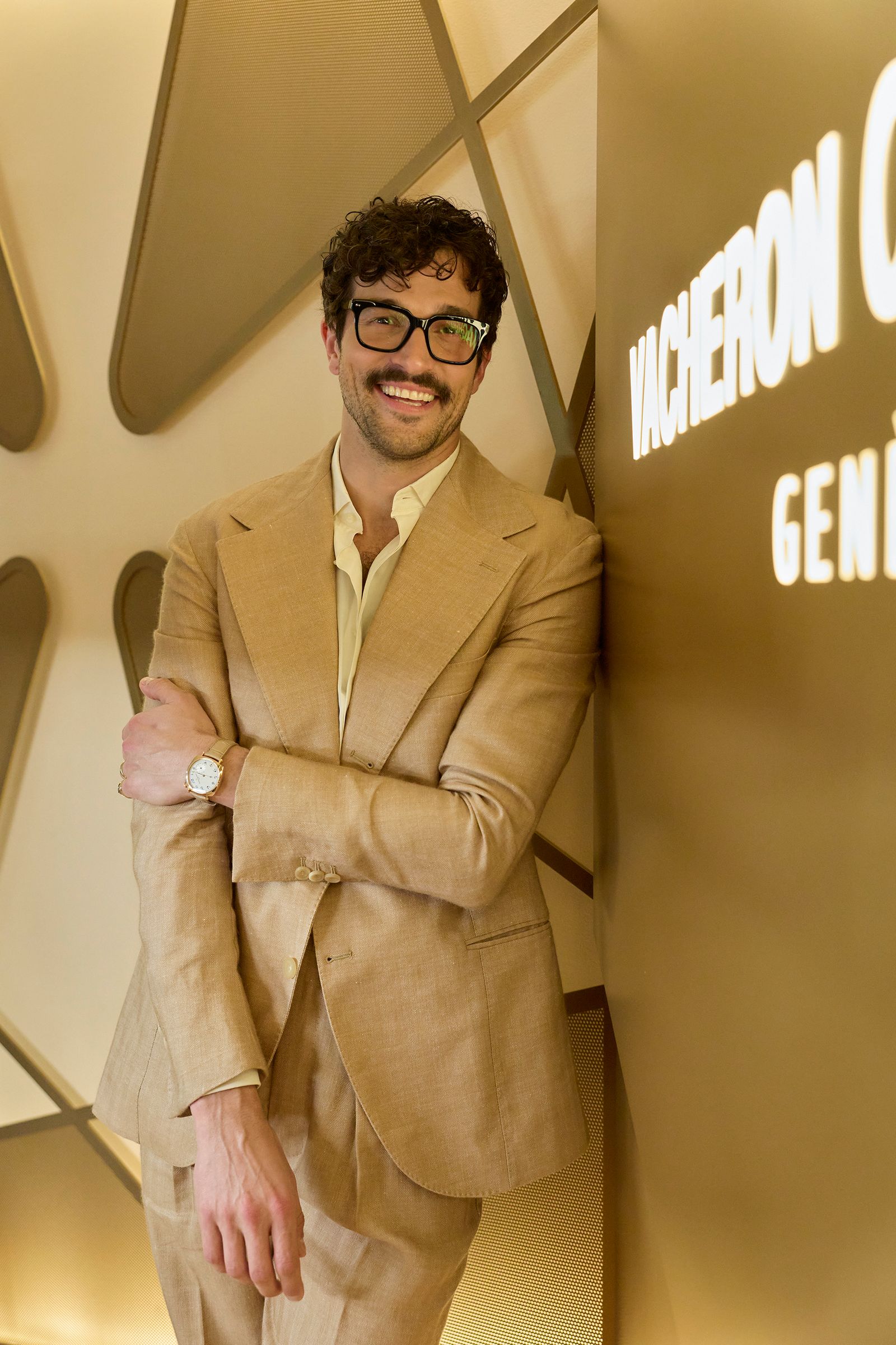 Image may contain blazer, coat, jacket, face, happy head, person, smile, accessories, glasses, dimples and adult