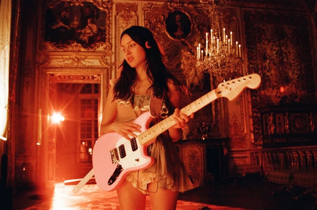 Image may contain guitar, instrument, person, performer, solo act, adult leisure activities and music