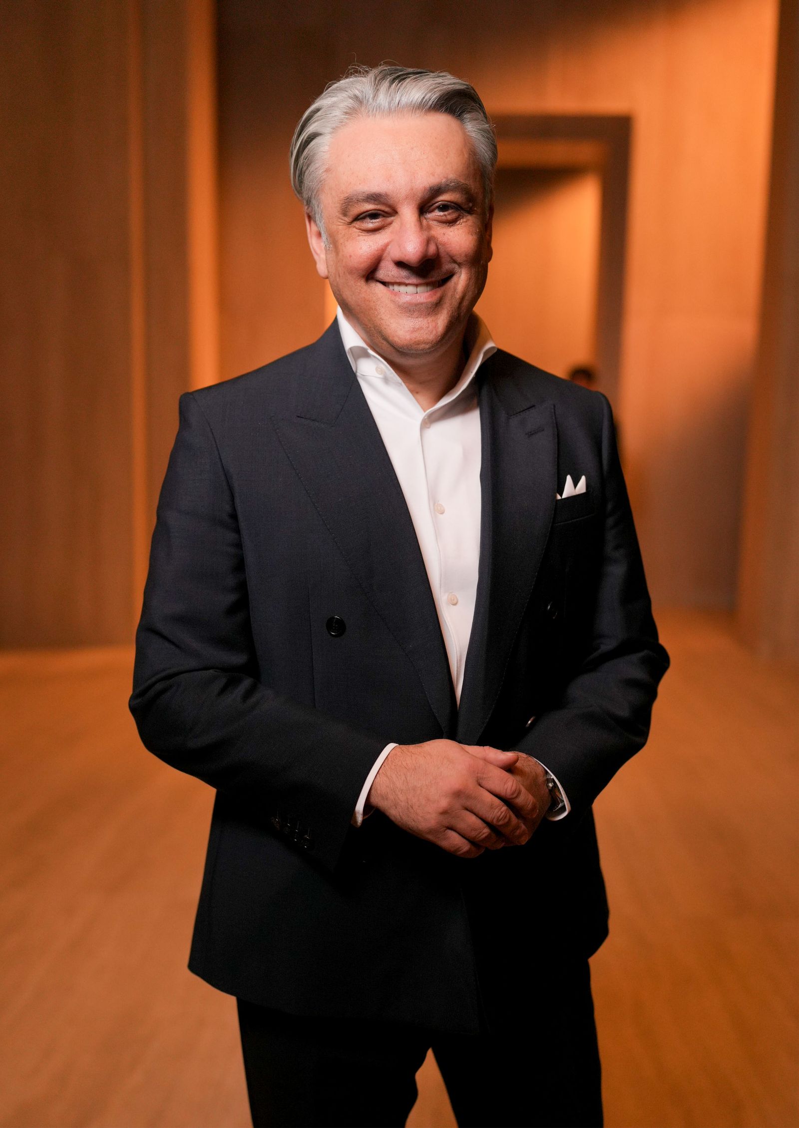 Image may contain Luca de Meo Blazer Clothing Coat Jacket Face Happy Head Person Smile Photography and Portraits