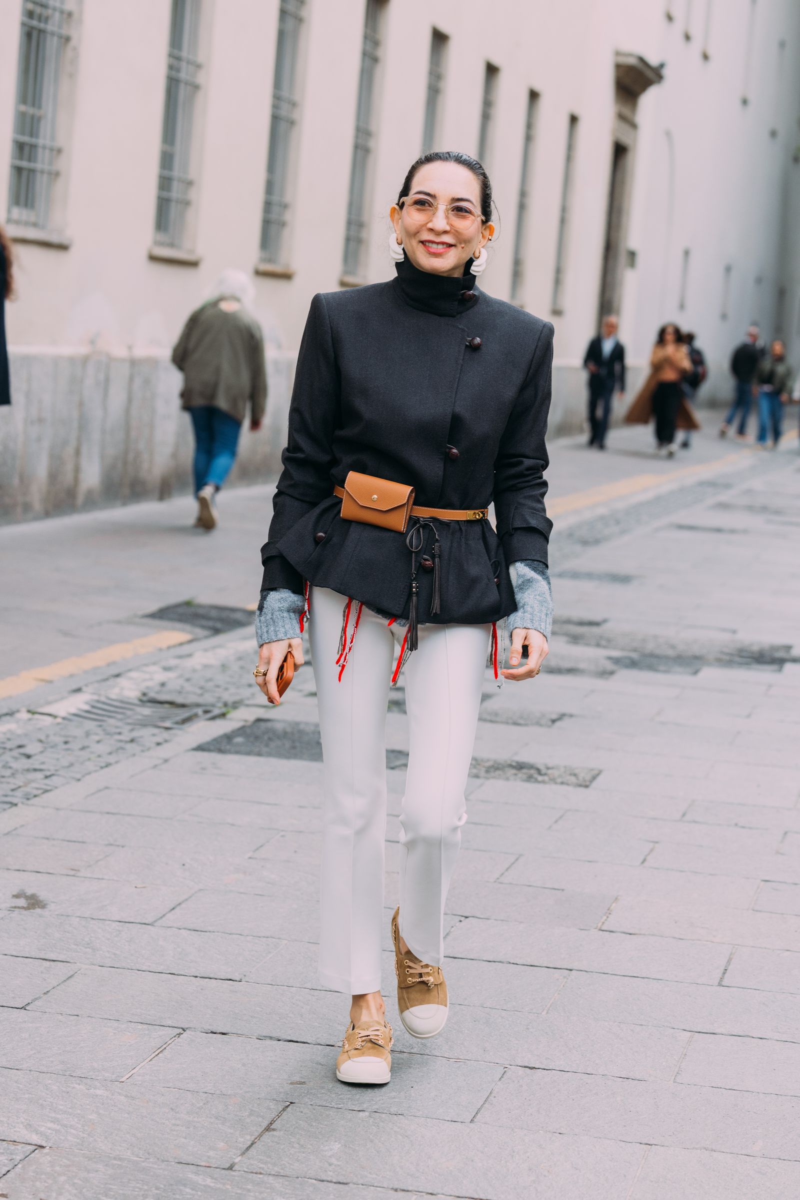 Image may contain people standing, clothing, pants, pedestrian coats and adults