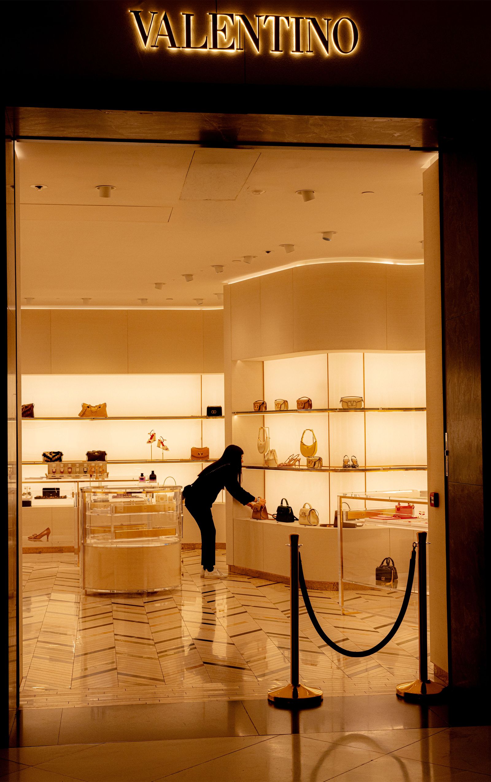 Image may contain store adult architecture construction jewelry store accessories bags handbags and interior