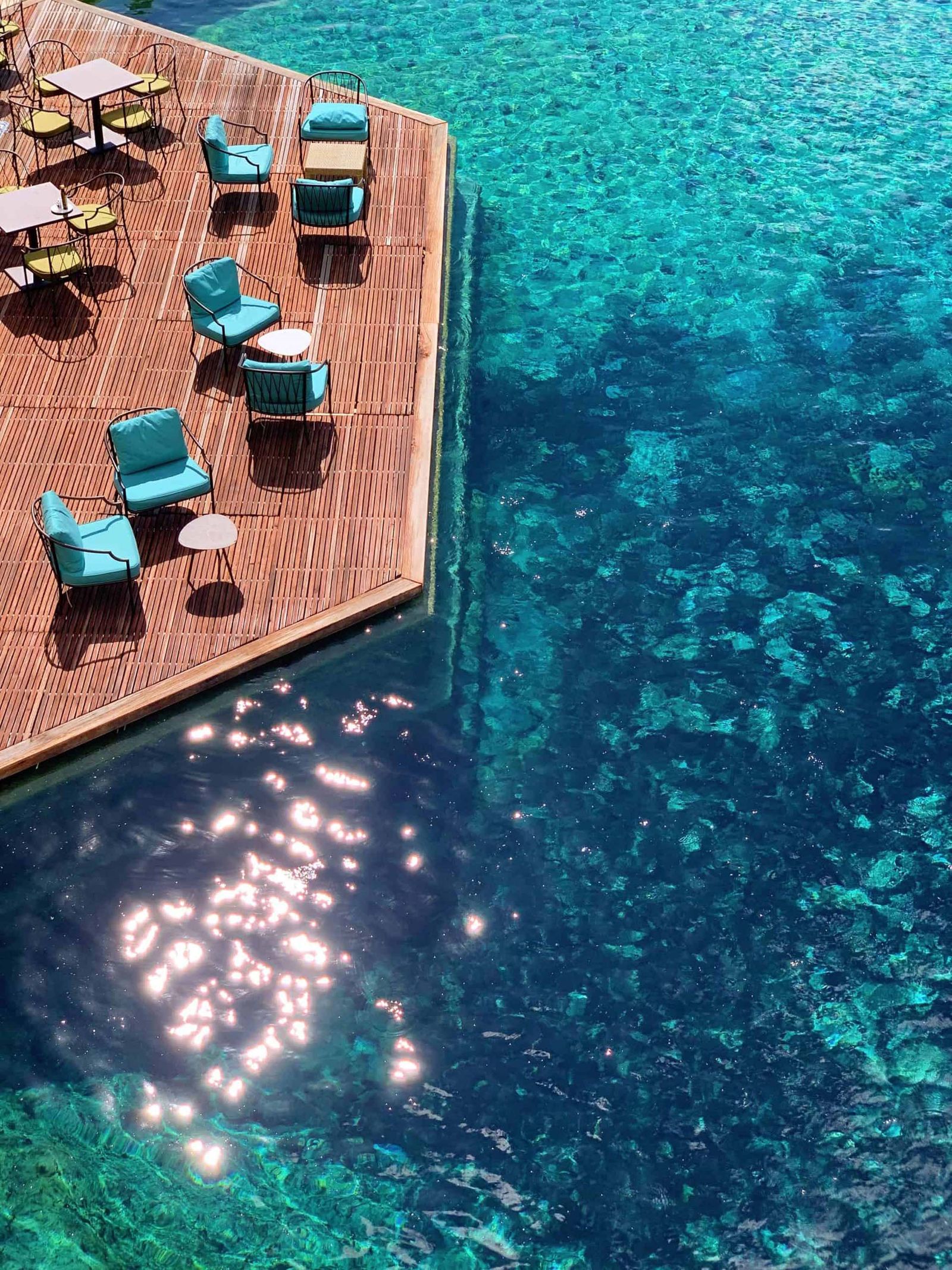 Image may contain pool water, swimming pool, outdoor nature, sea chairs, furniture aerial view, seashore and coastline