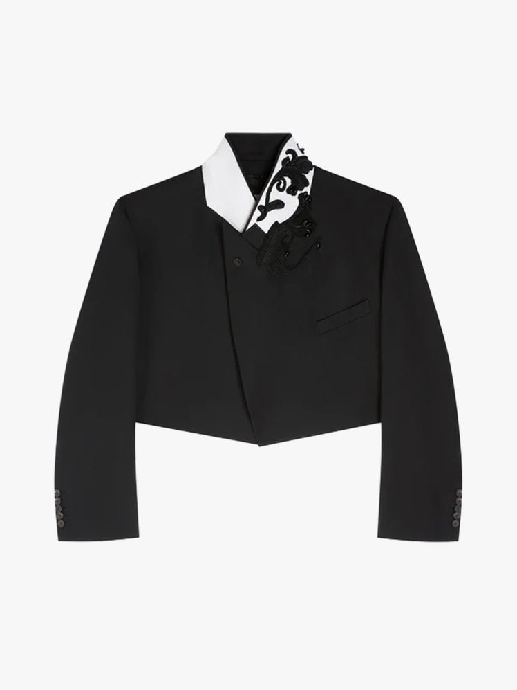 Image may contain: clothing, formal wear, suit, tuxedo, coat, jacket, long sleeves, sleeves, blazer, shirt and accessories