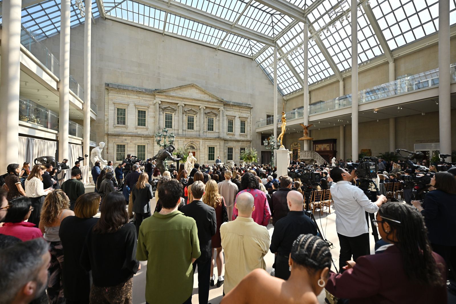Image may contain adult urban clothing, footwear, windows and crowds
