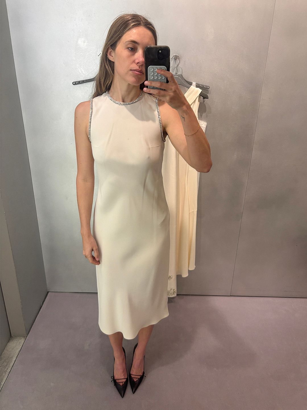 Image may contain clothing, dresses, adult footwear, shoe sleeves, evening gowns, formal wear and high heels