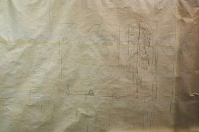 A sketch showing a series of stick figures surrounding a table.