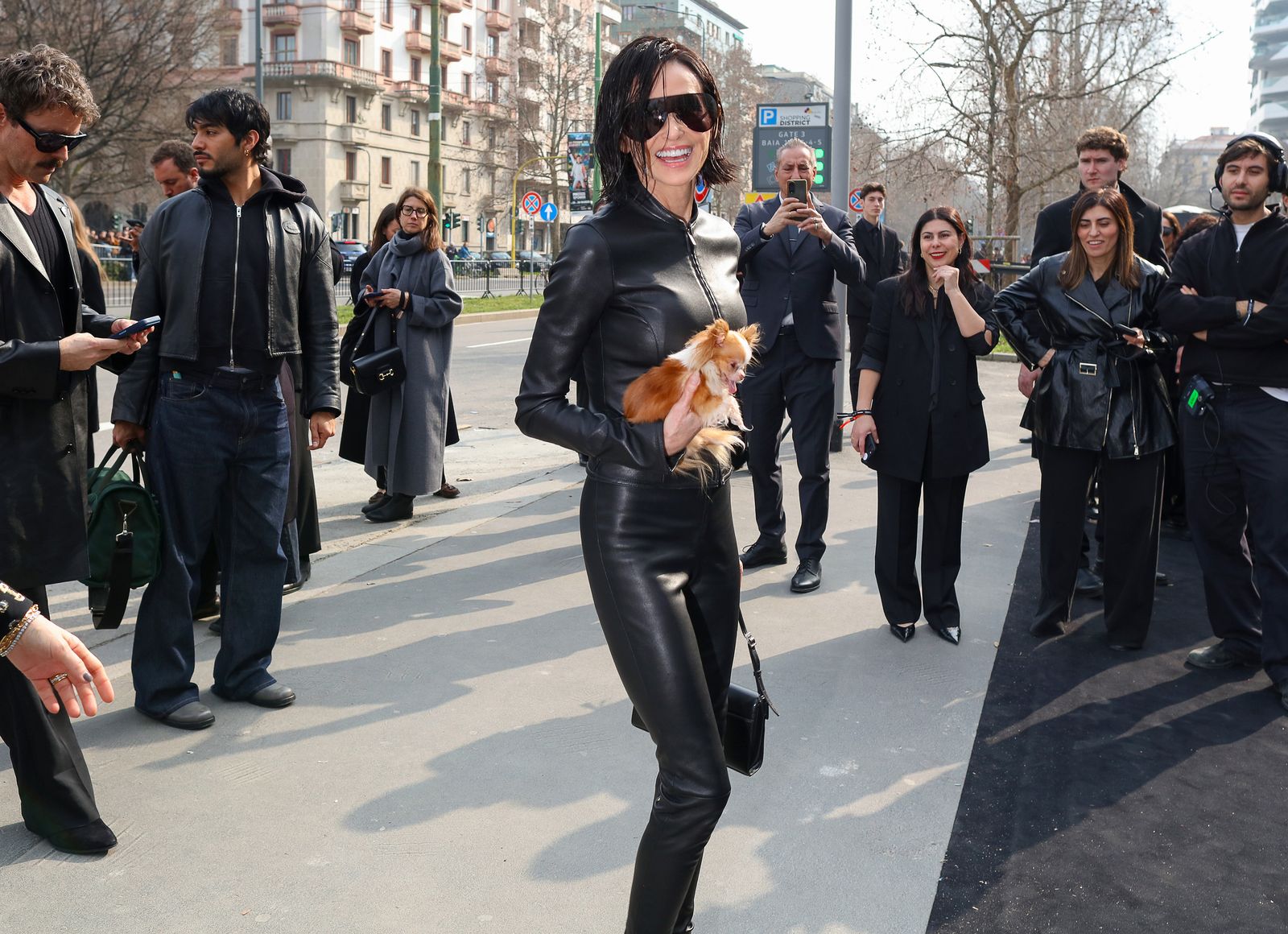 Image may contain Demi Moore Matt Crooks Adult Pedestrian Outfit Pants Photo Bomb Walking and Jacket