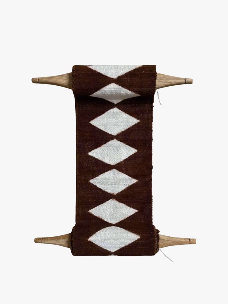Image may contain: home decor, rug, rug, ax, equipment, tools and weapons