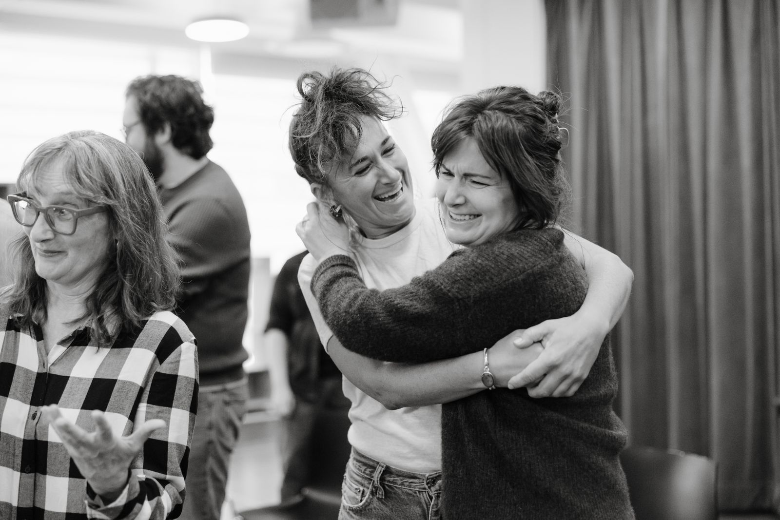 Image may contain face, head, people photography, portrait, happy smile, adult hugging people and watch
