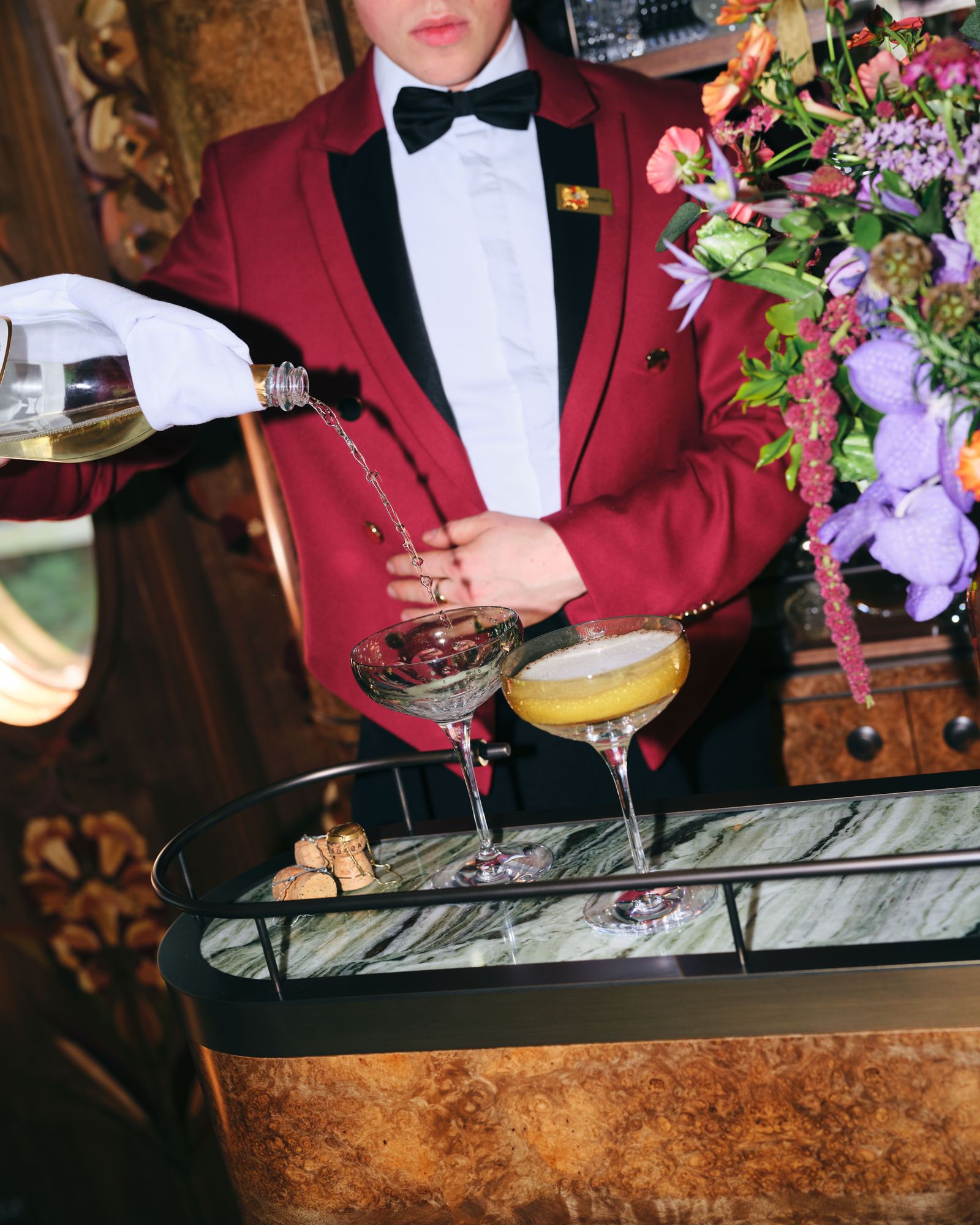 Image may contain clothing, formalwear, cooking, food, food pouring, food display, adult and glass