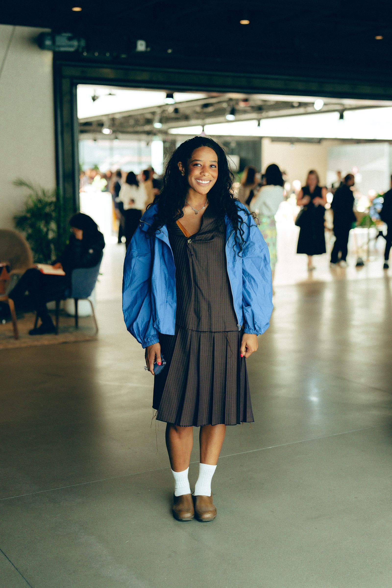 Image may contain clothing, coats, faces, people photography, portrait jackets, adults, teens skirts, pants and joy