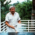 American artist Robert Rauschenberg (born Milton Ernst Rauschenberg) smiles as he prepares the canvas for one of his paintings, following the technique of assemblage painting. Florida (USA), 1970s.. (Photo by Mondadori via Getty Images)