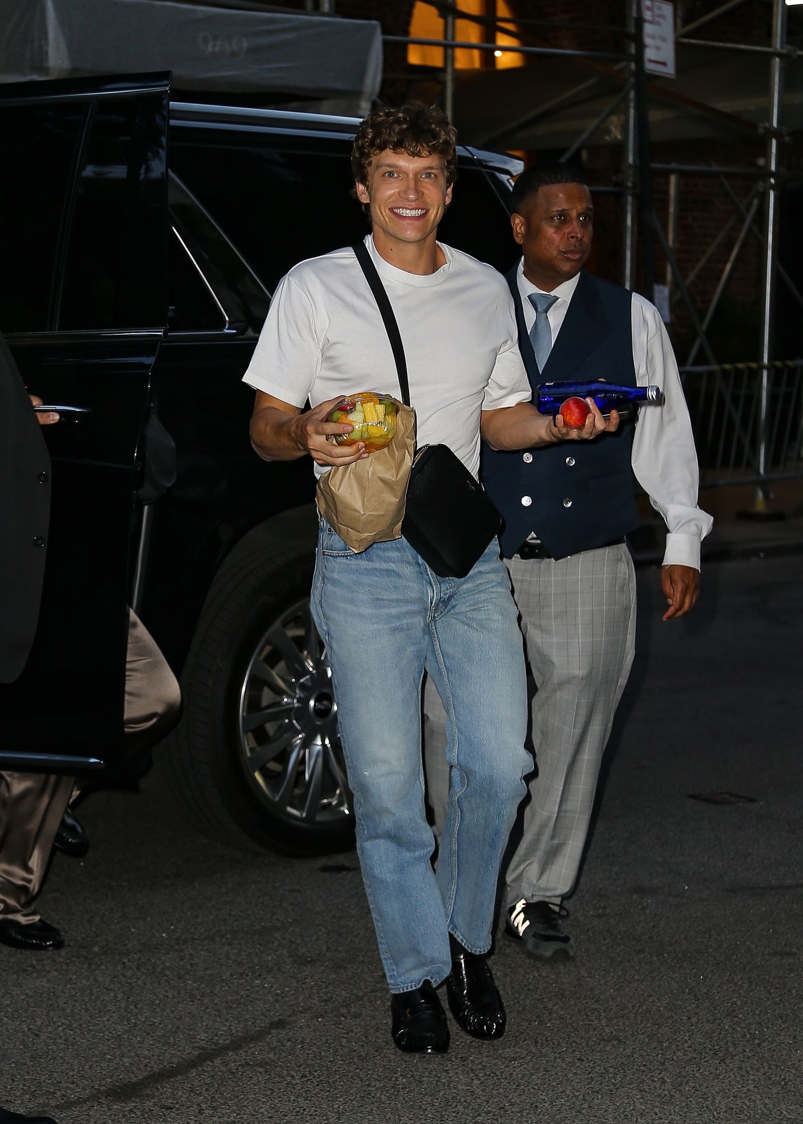 Connor Storrie enjoys trendy snacks while arriving in New York