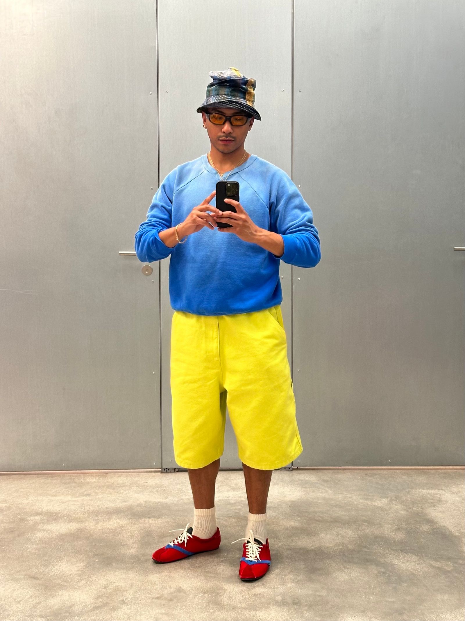 Image may contain Alexander Spit Clothing Shorts Adult Standing Pants Photography Sleeves Face and Head