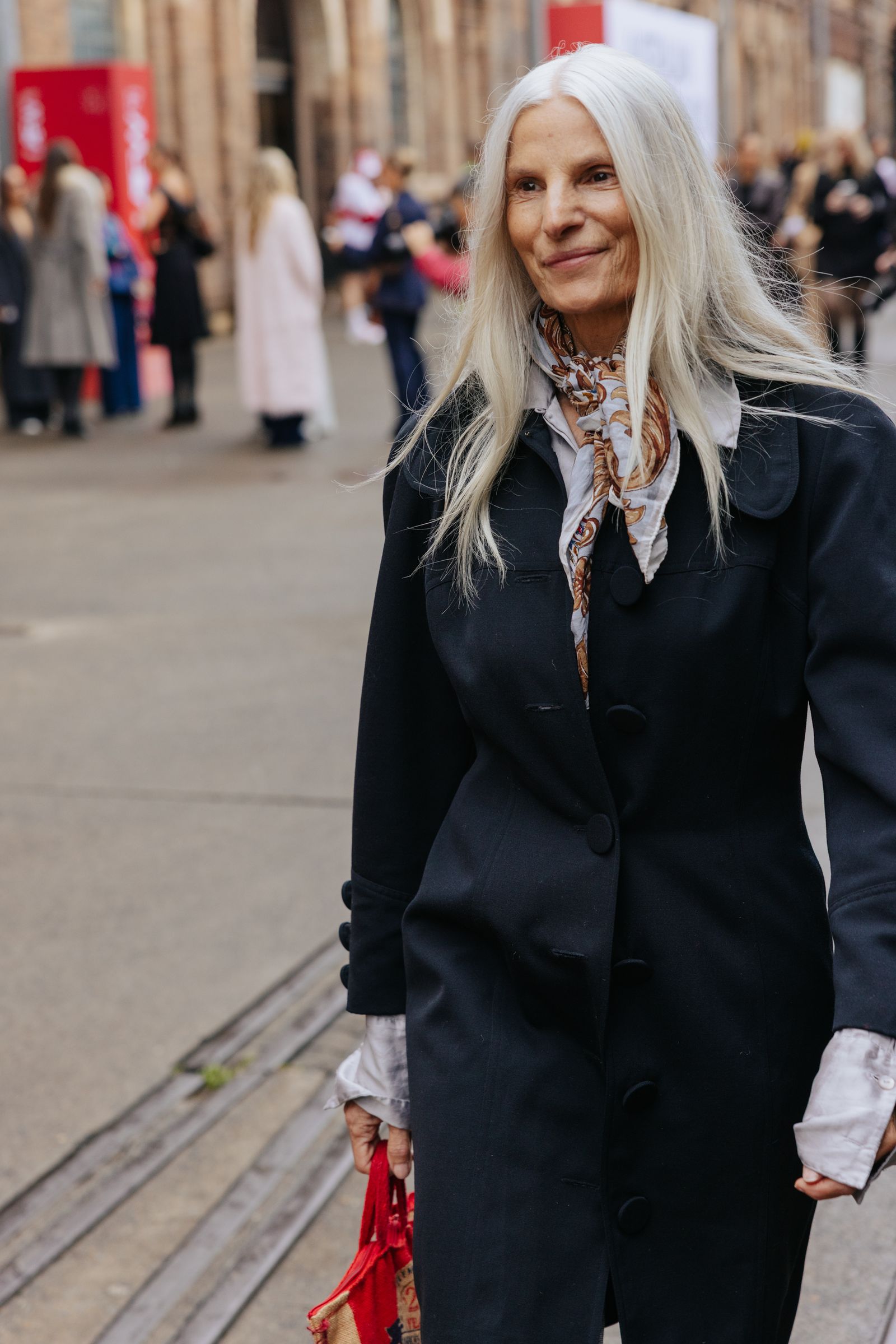 Image may show people, blonde accessories, bags, handbags, adult clothing and coats