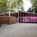 A glass building with purple lights and a brick exterior with the words "Canada."