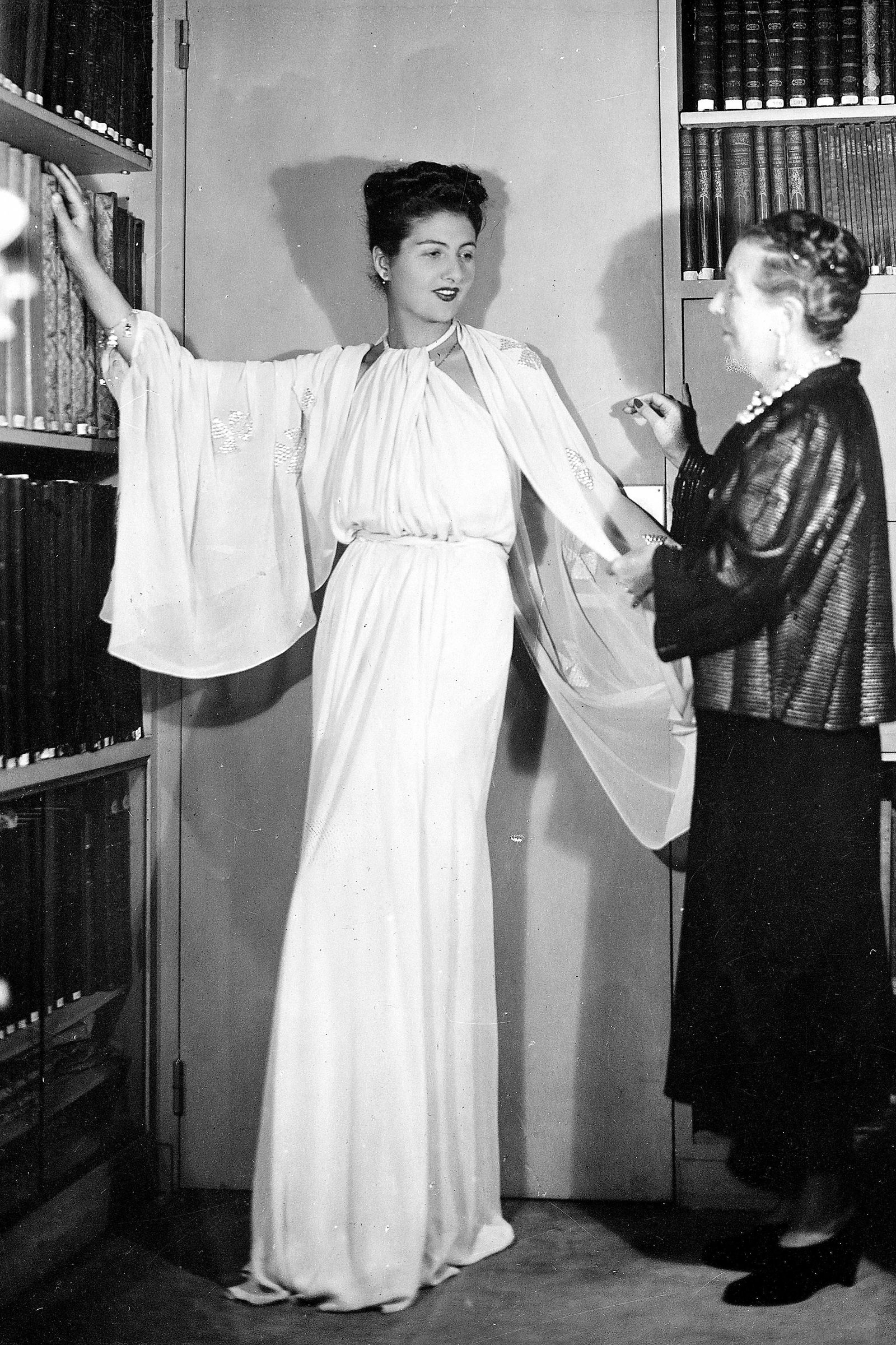Image may contain Maria Caniglia Jeanne Lanvin people clothing, dresses, adult weddings, fashion formalwear and books