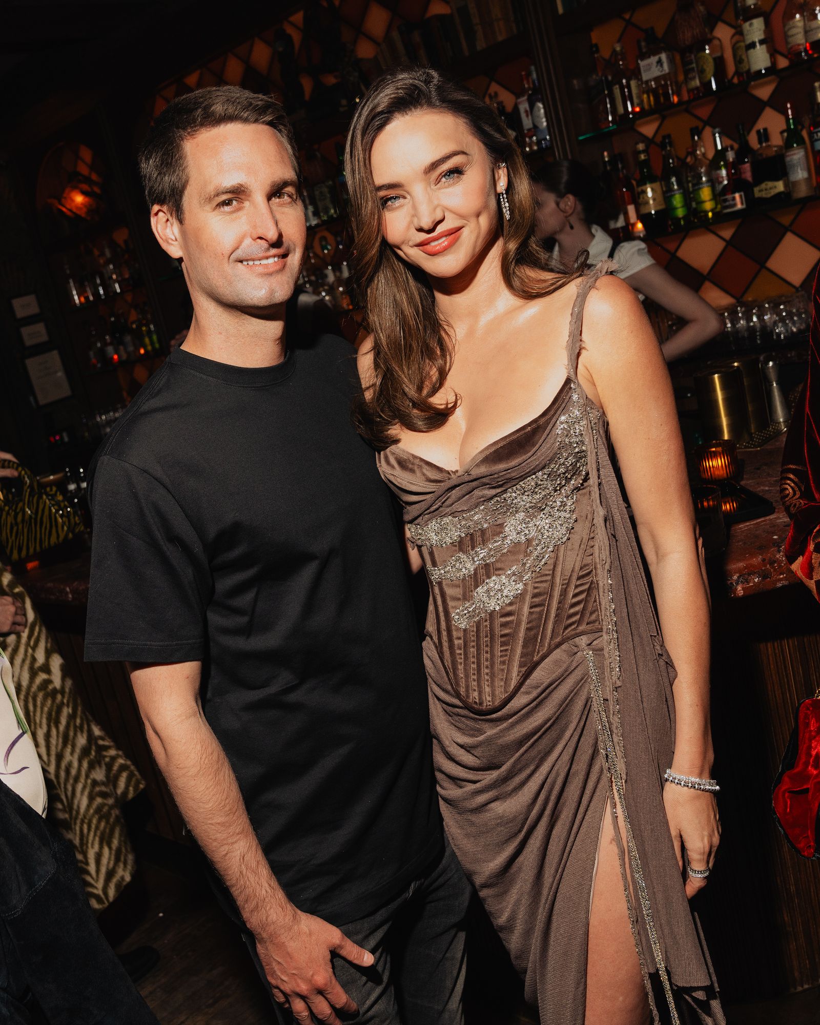 Image may contain Evan Spiegel Miranda Kerr Urban Person Photobombing Adult Face and Head