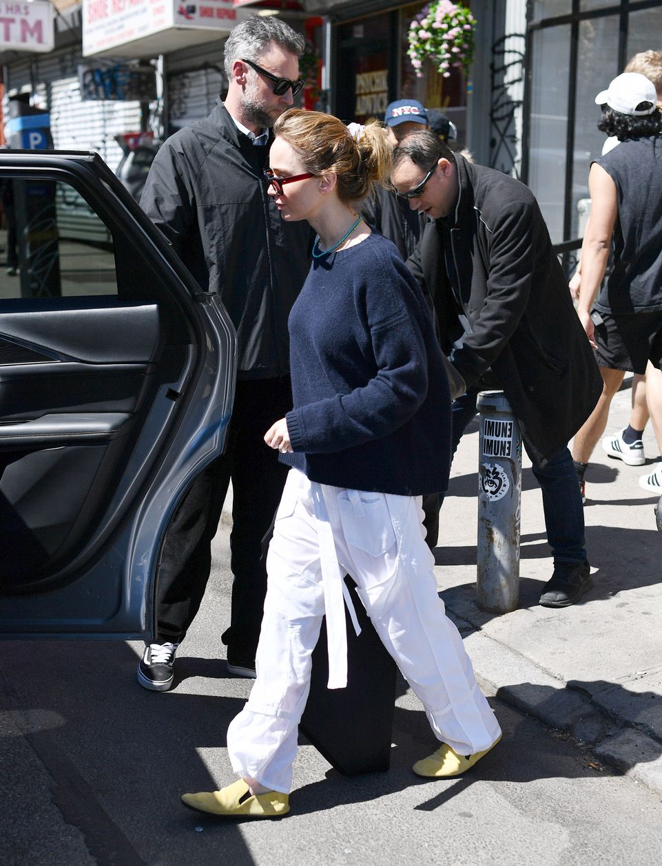 Image may contain Jennifer Lawrence Pedestrian Clothing Footwear Shoes Walking Pants Adult City and Road