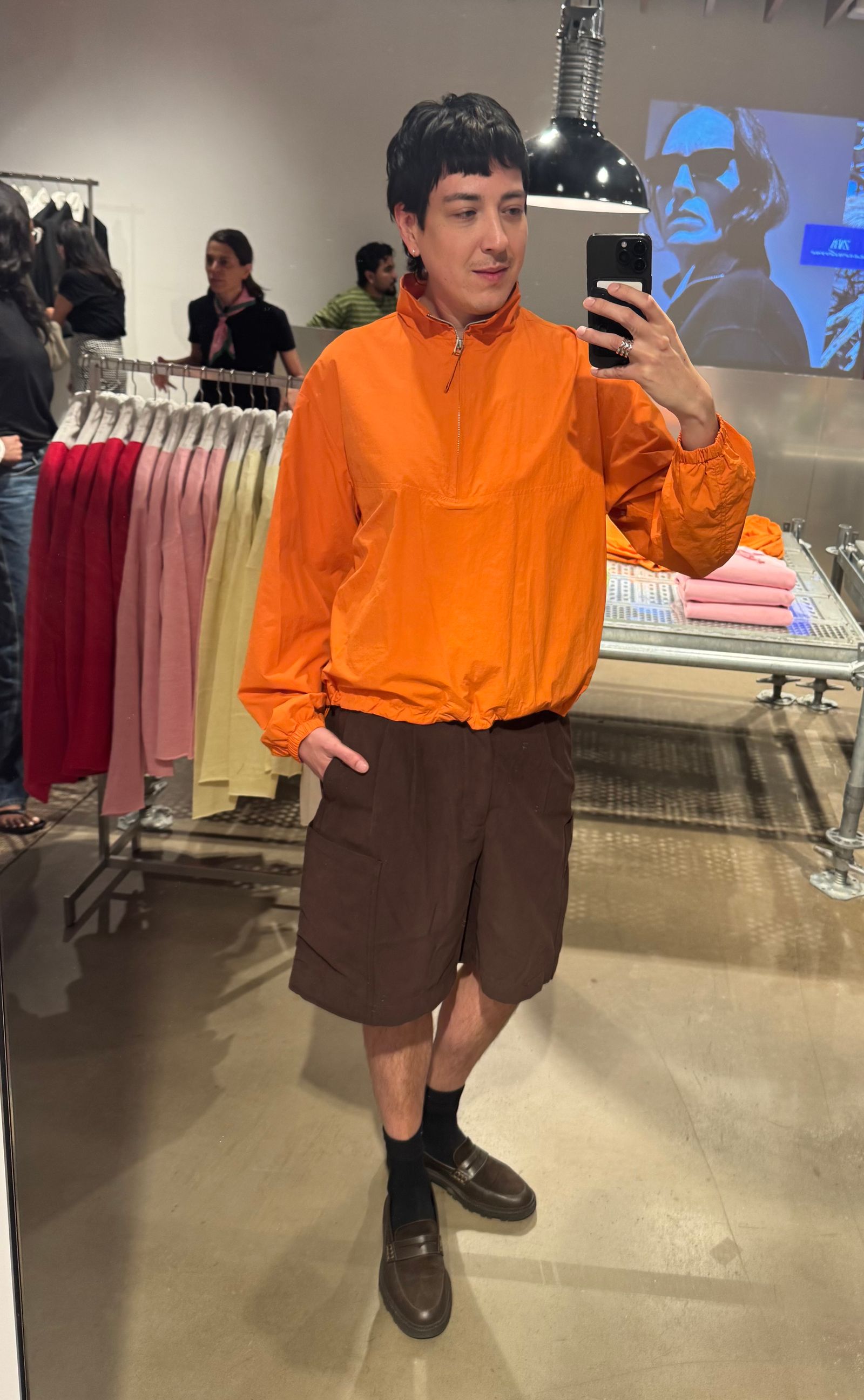 Image may contain clothing, sleeves, adult, shorts, accessories, bag, handbag, black hair, hair, face and head