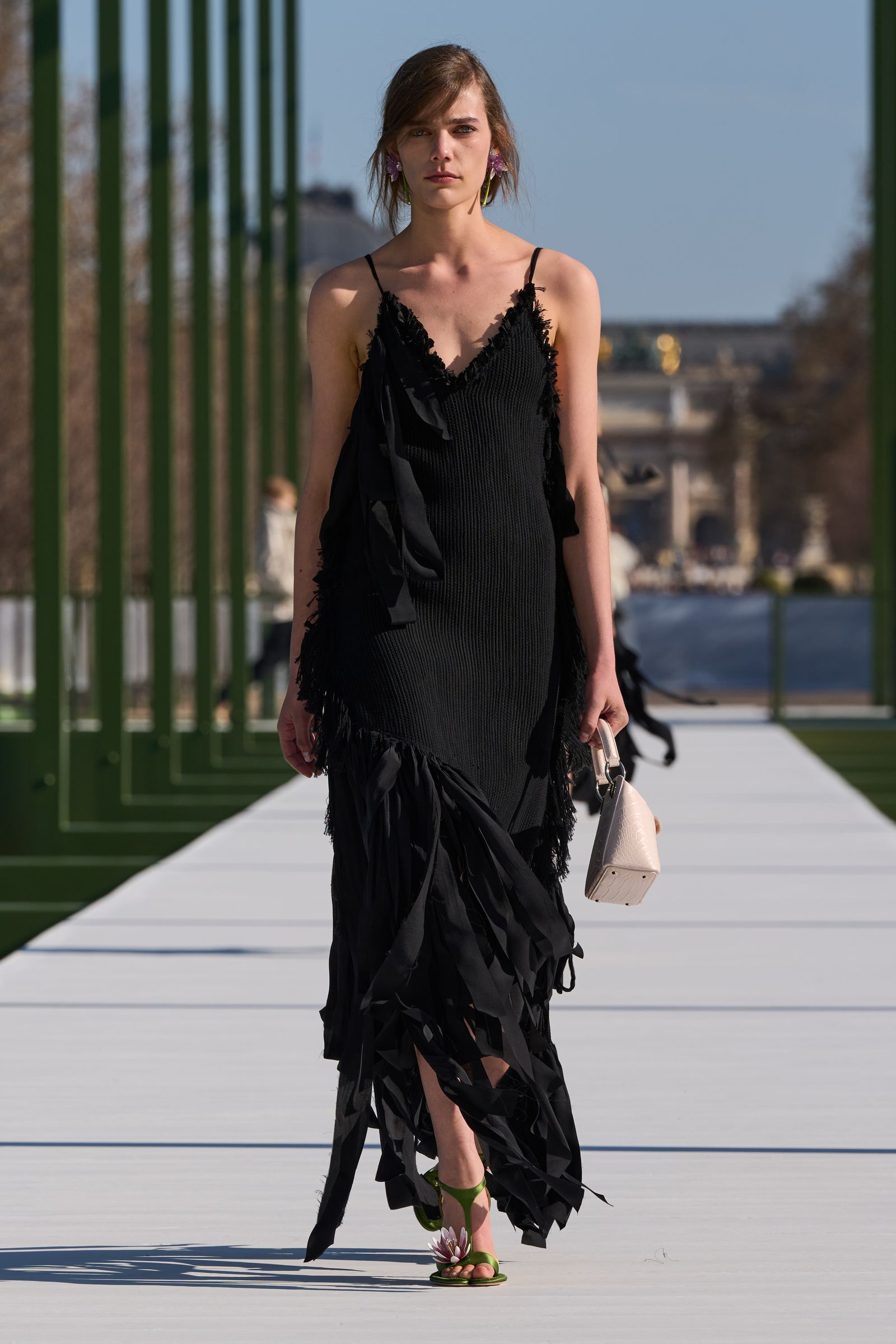 Image may contain clothing, gown, formal wear, adult, fashion evening wear, accessories, bag, handbag and runway