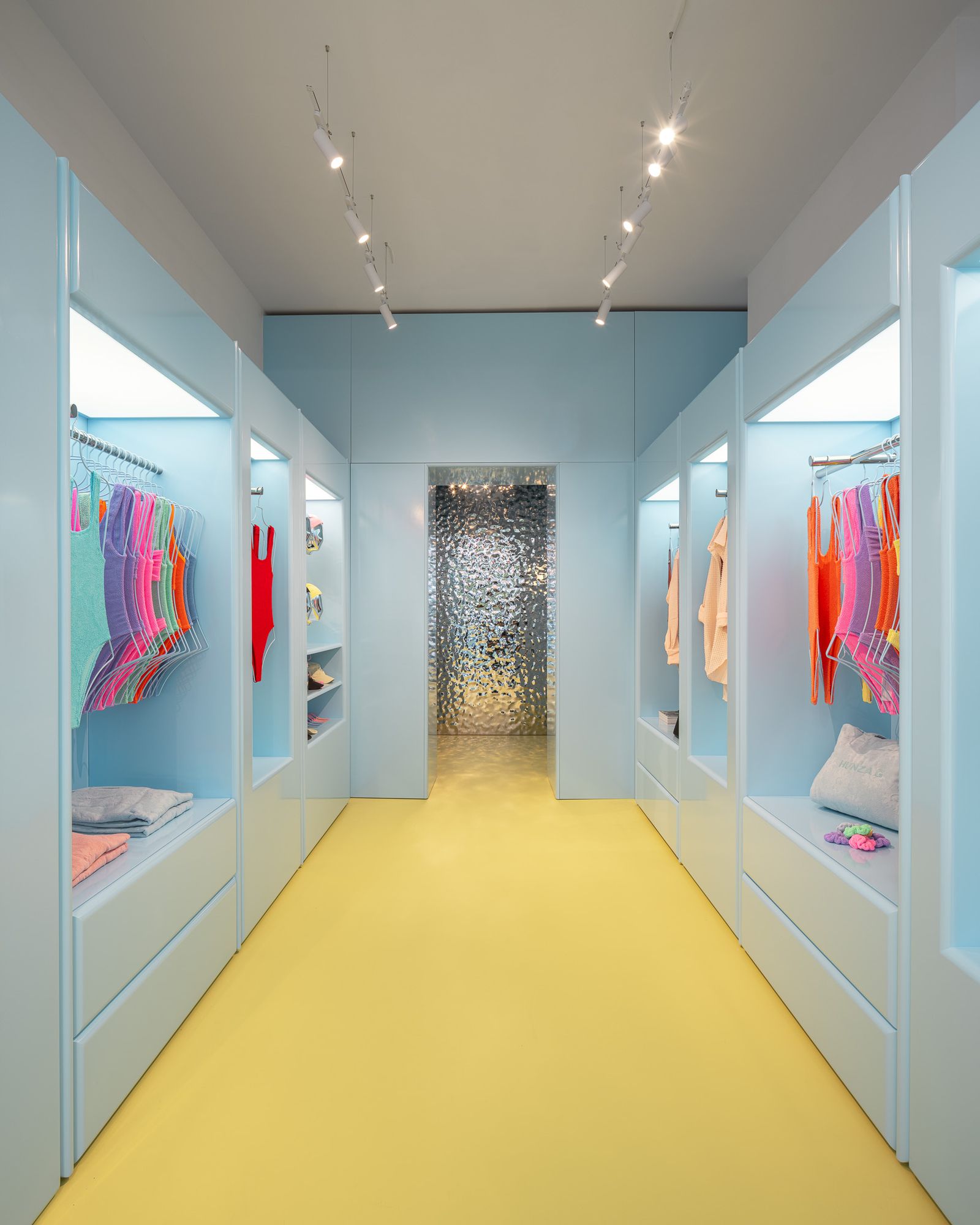 Image may contain interior room walk-in wardrobe, furniture, dressing room and wardrobe