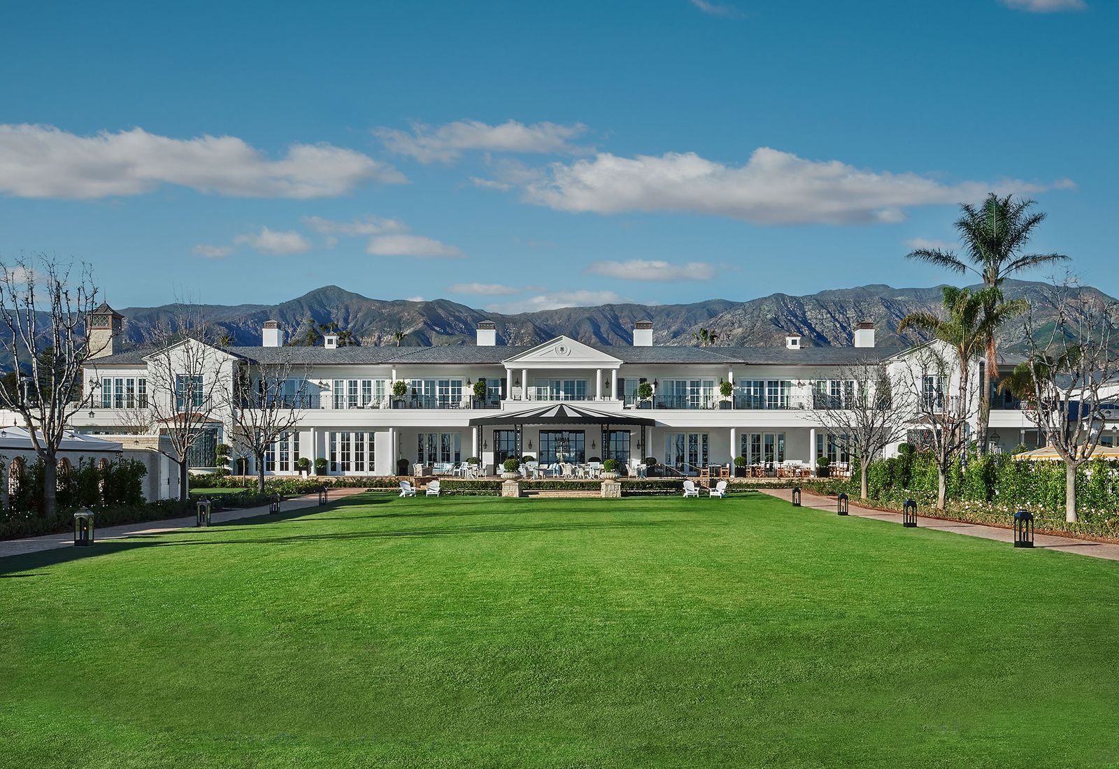 Image may contain grass, plants, chairs, furniture, lawn, suburb, people, building, architecture and housing
